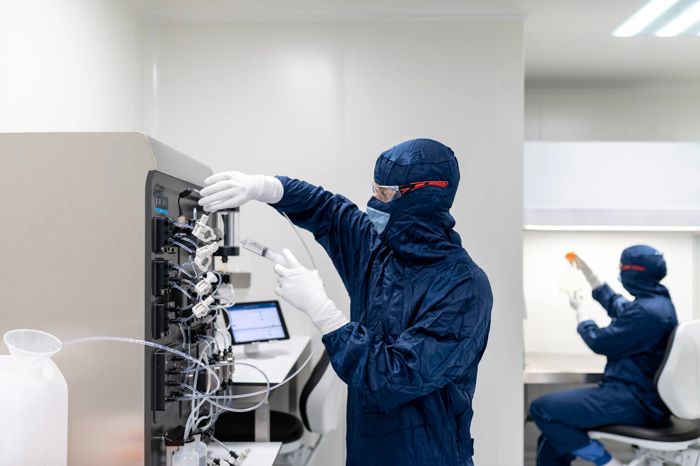 Laboratory team working with controlled equipment